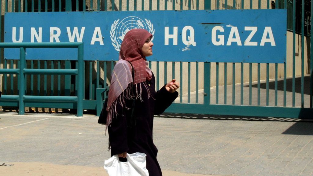 A woman walks past the UNRWA headquarters in Gaza