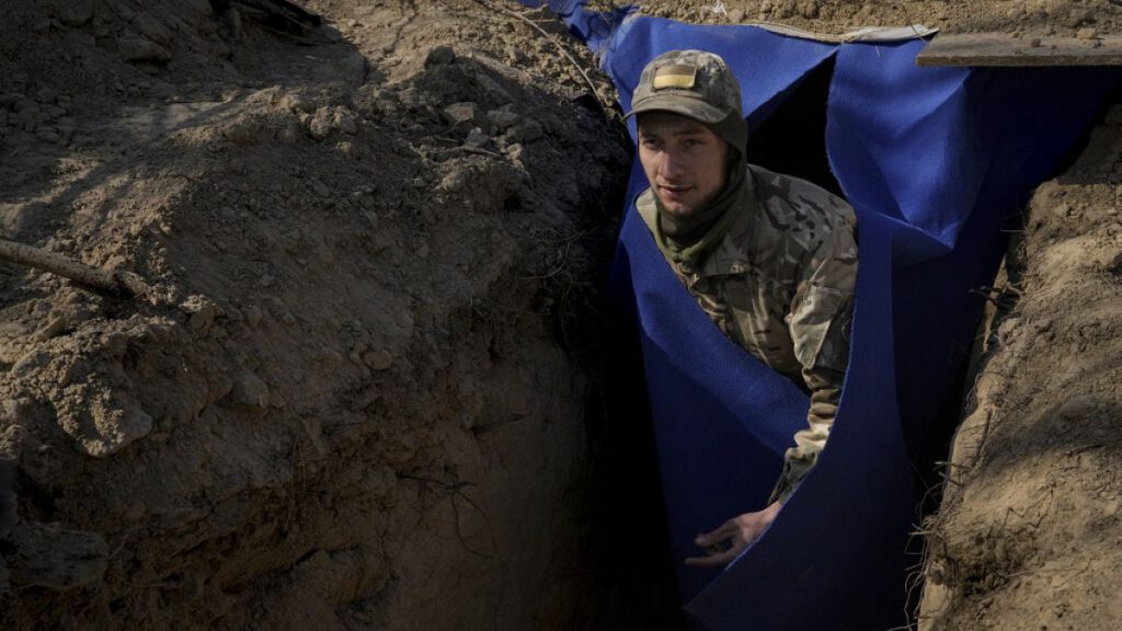 A Ukrainian serviceman exits a bunker on the outskirts of Kyiv, Ukraine, Sunday, March 20, 2022