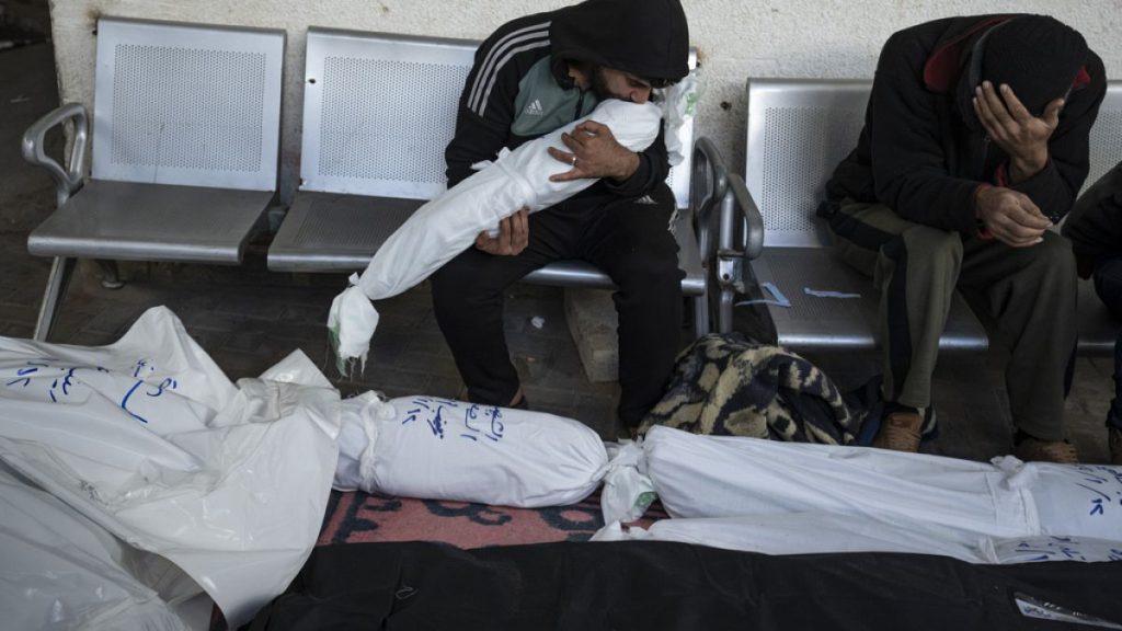 Palestinians mourn relatives killed in the Israeli bombardment of the Gaza Strip in Rafah on Saturday