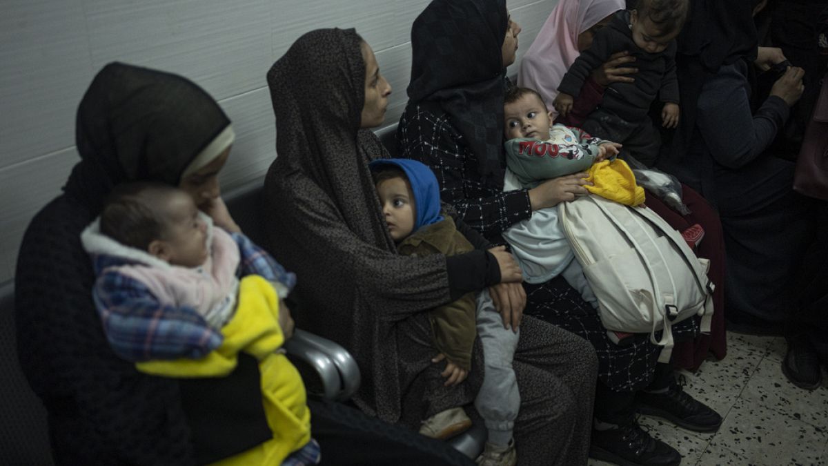 Palestinians line up with their children to receive vaccination against diseases, which recently entered Gaza as part of aid, in Rafah, southern Gaza Strip.