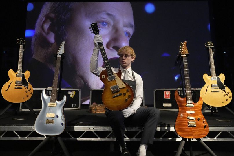 Pracownik Christie's pokazuje gitarę Gibson Kalamazoo, której właścicielem jest między innymi piosenkarz, autor tekstów i bohater gitary Dire Straits, Mark Knopfler,