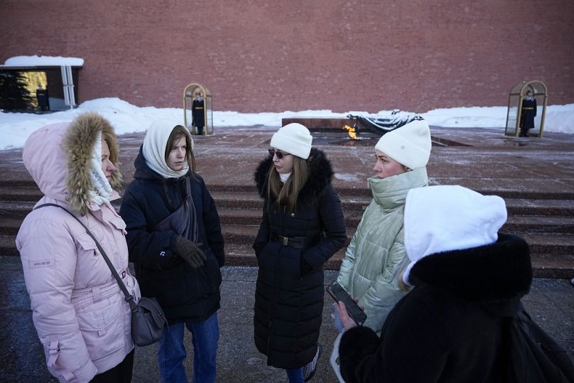 Żony rosyjskich żołnierzy zmobilizowanych do walk na Ukrainie rozmawiają ze sobą po złożeniu kwiatów na Grobie Nieznanego Żołnierza pod murem Kremla w Moskwie.