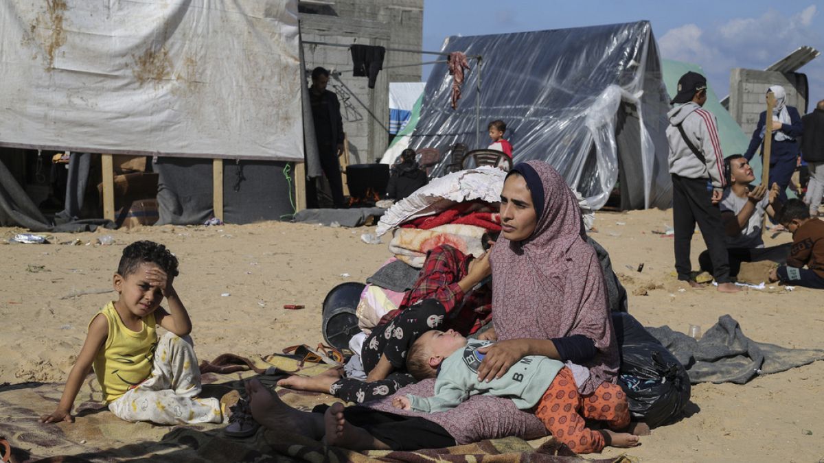 FILE: Palestinians converge for a free meal in Rafah, Gaza Strip, Thursday, Dec. 21, 2023.