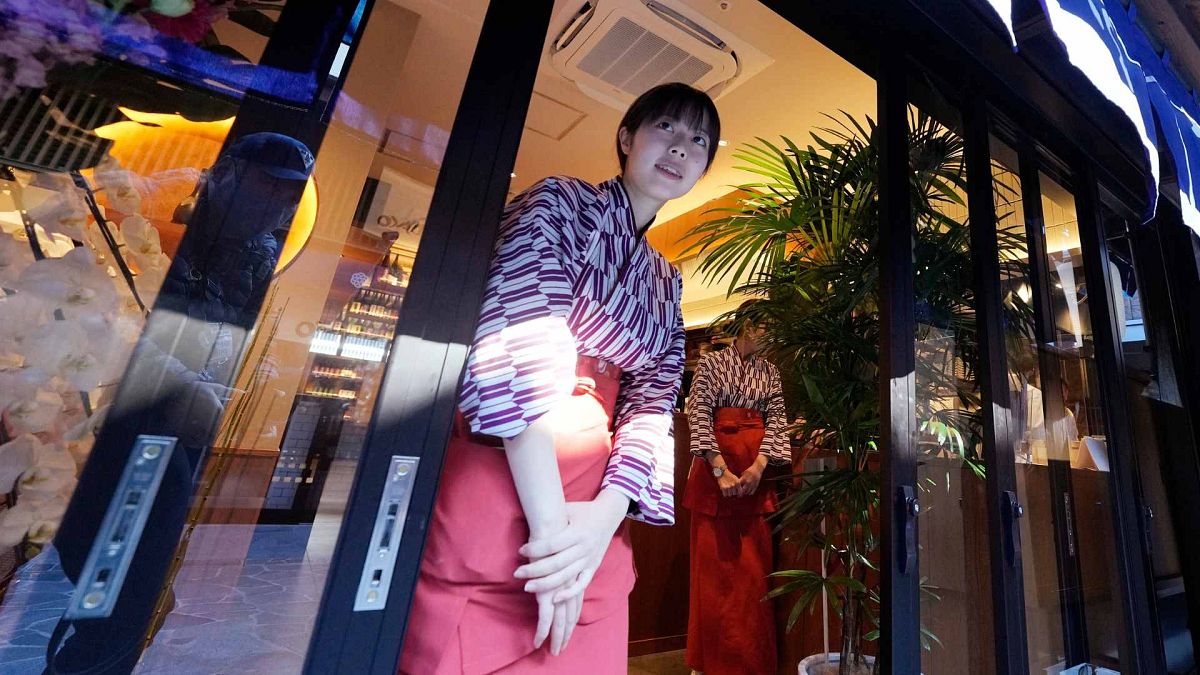 Staff members wait for guests at an eel restaurant at