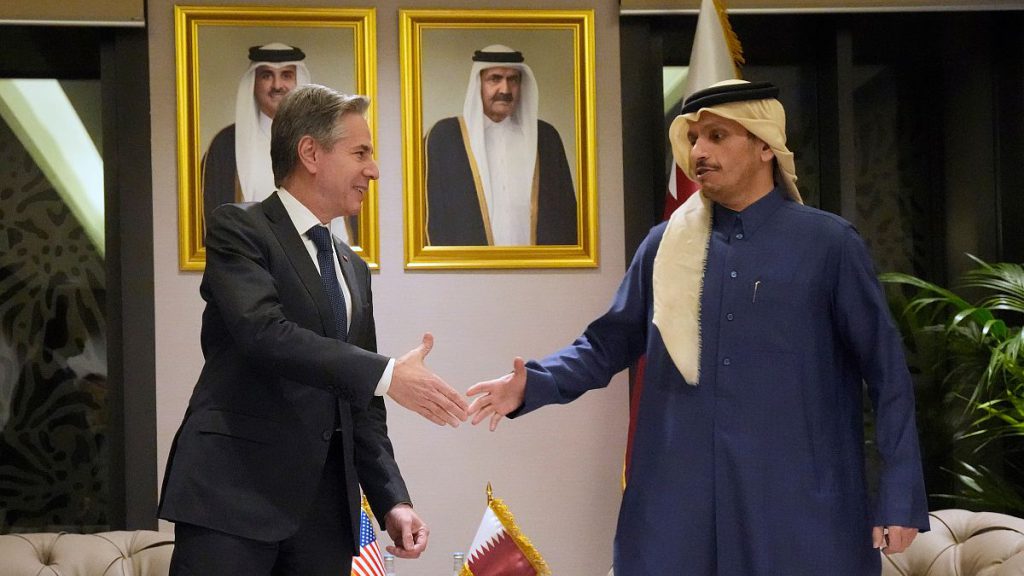 US Secretary of State Antony Blinken, left, shakes hands with Qatar