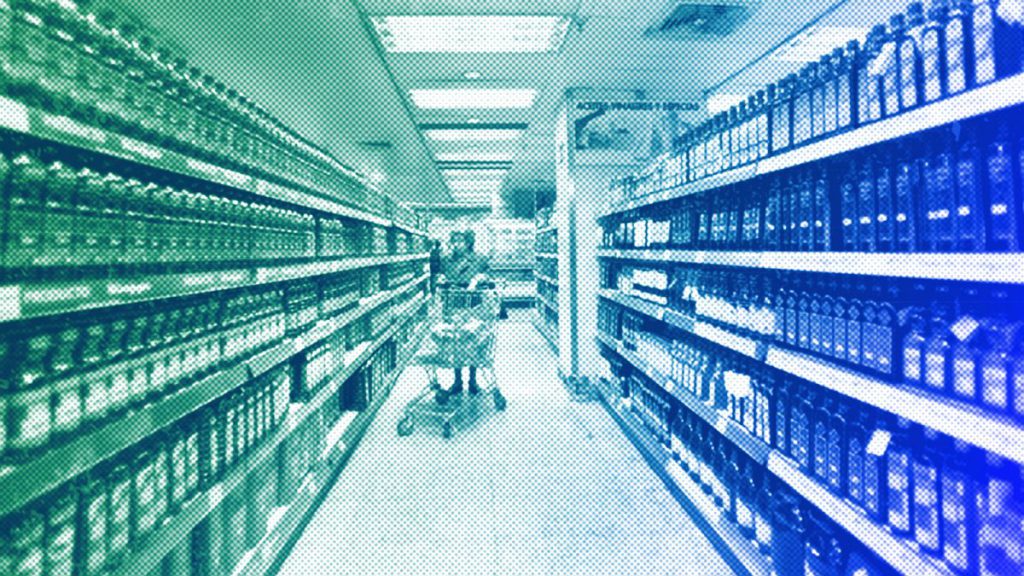 A woman pushes her shopping trolley in a supermarket, in Madrid, October 2008