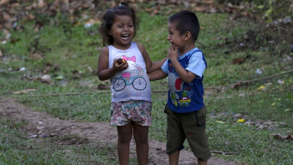 Children laugh while eating a local fruit in the Chambira community, in Peru