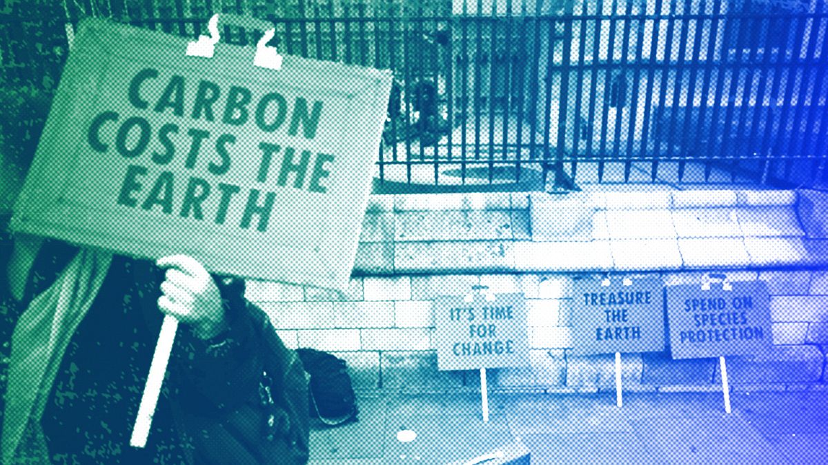 A woman holds a placard as she participates in a demonstration on the budget outside Parliament in London, March 2020