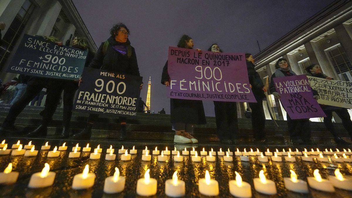 Members of the women #NousToutes group hold placards that read,