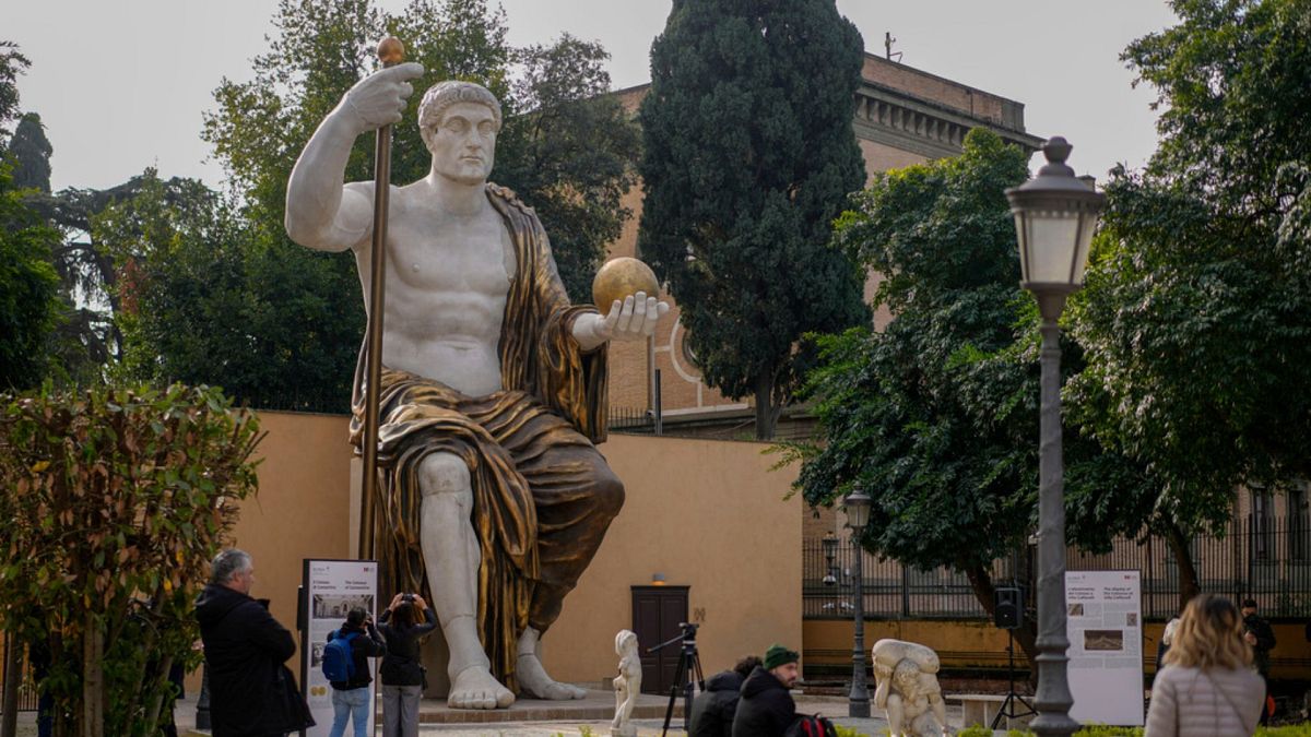 Visitors admire a massive, 13-meter (yard) replica of the statue Roman Emperor Constantine commissioned for himself after 312 AD