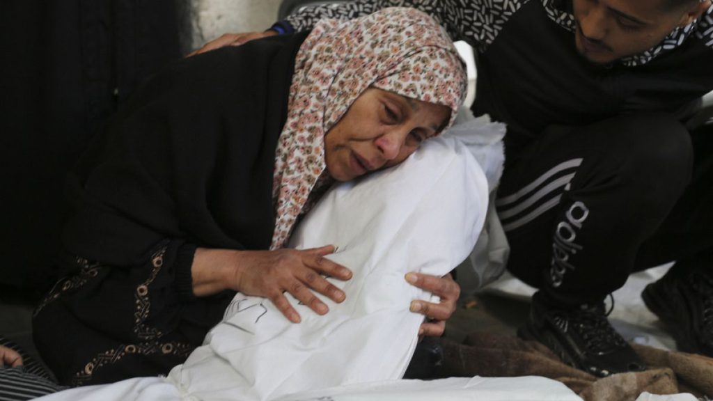FILE - Palestinians mourn relatives killed in the Israeli bombardment on Rafah, Gaza Strip, Thursday, Dec. 7, 2023.
