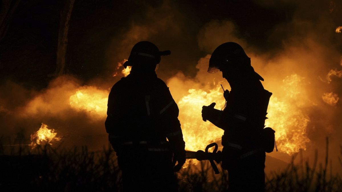 Firefighters extinguish a fire after a Russian attack on residential neighborhood in Kharkiv, Ukraine, on Saturday, Feb. 10, 2024.