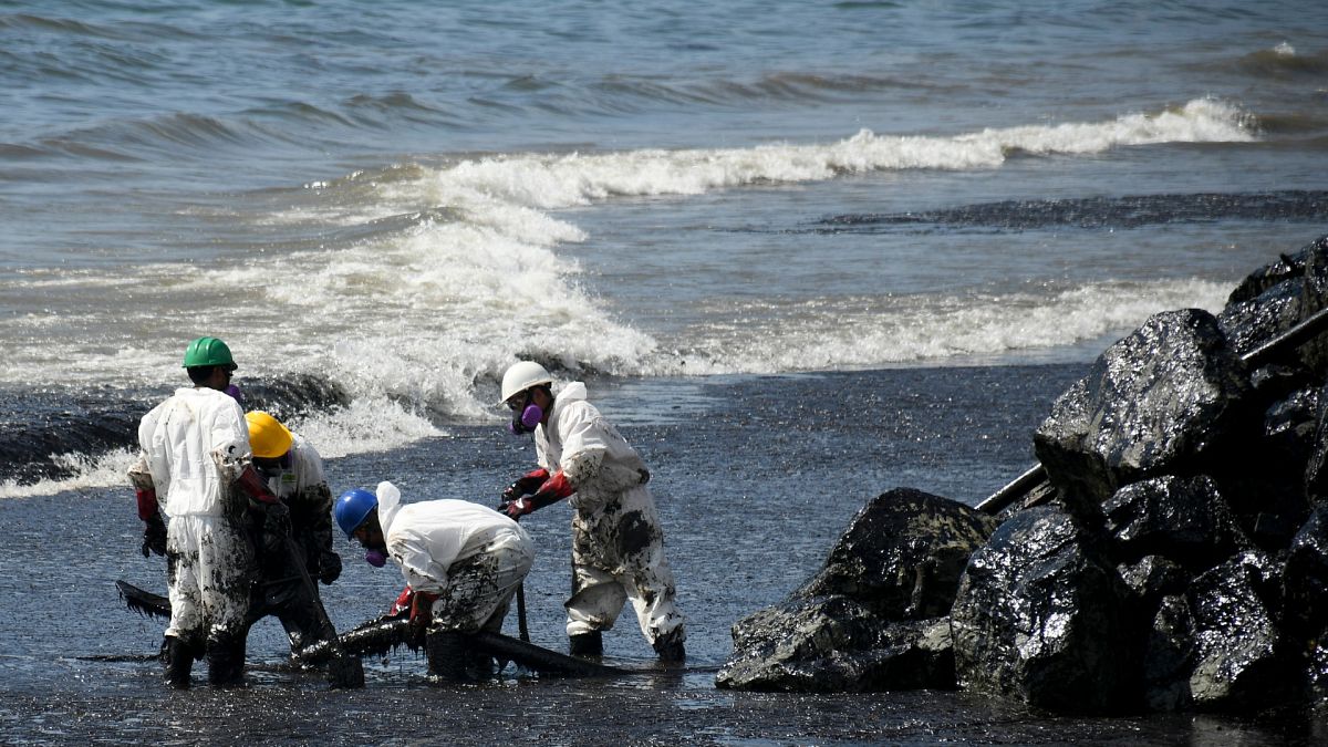 Workers from state own Heritage Petroleum Oil and Gas Company clean up an oil spill that reached Rockly Bay beach, in Scarborough, south western Tobago, Trinidad and Tobago.