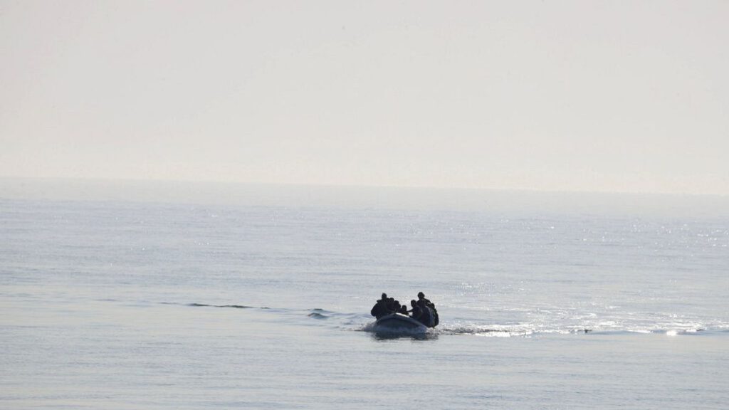 FILE - A group of people thought to be migrants arrive in an inflatable boat at Kingsdown beach after crossing the English Channel, near Dover, Kent, England, 2020.