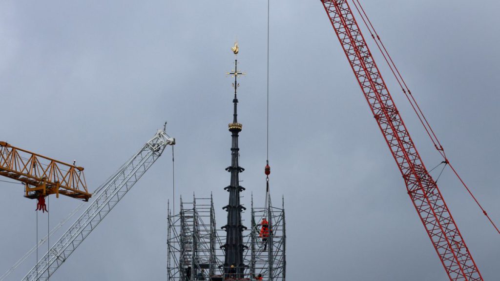 Scaffolding is being removed around the spire of Notre Dame de Paris cathedral, showing the rooster and the cross, Monday, Feb. 12, 2024 in Paris