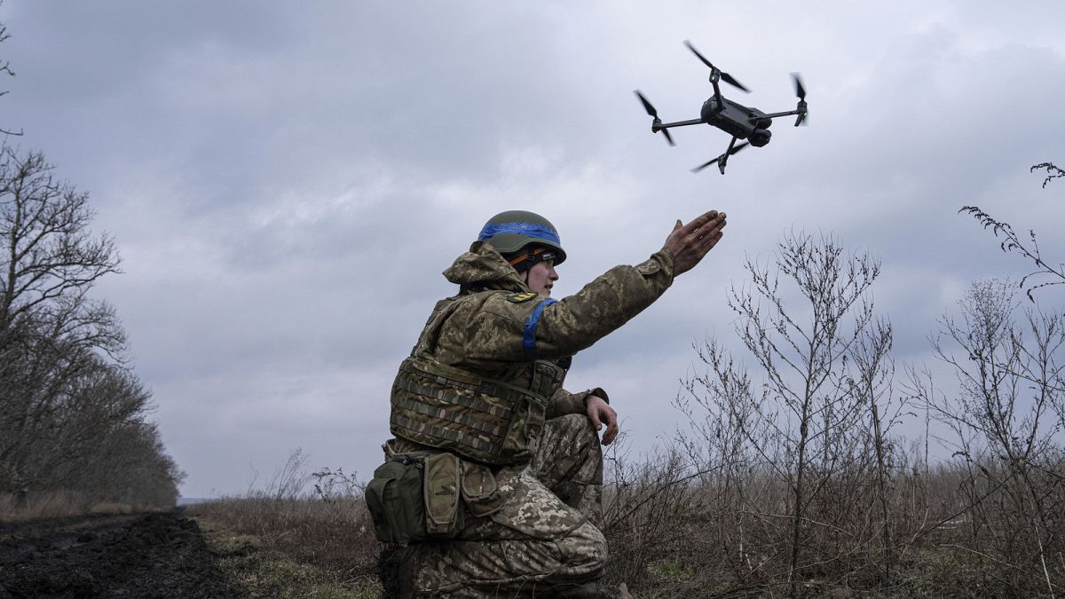 A Ukrainian serviceman of the 68 Oleksa Dovbush hunting brigade, launches a drone at the frontline near Vuhledar, Ukraine, Wednesday, Feb. 22, 2023.