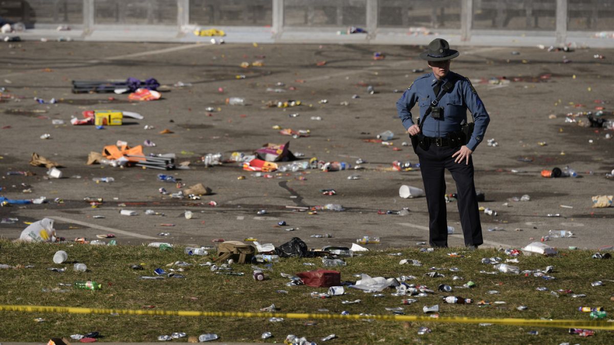 A law enforcement officer looks around the scene following a shooting at the Kansas City Chiefs NFL football Super Bowl celebration in Kansas City, Mo. 14/2/24.