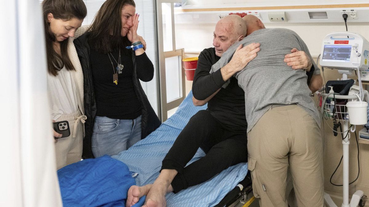 Hostage Luis Har, center, is hugged by relatives after being rescued from captivity in the Gaza Strip, at the Sheba Medical Center on Feb. 12, 2024.