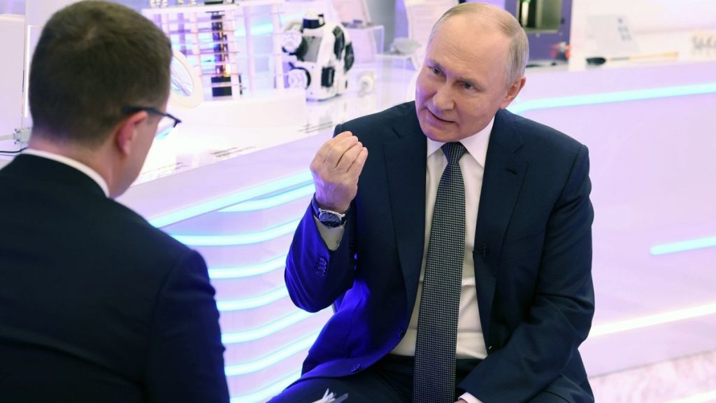 Russian President Vladimir Putin gesture while speaking during his interview with correspondent of Russian state television Rossiya 1 Pavel Zarubin in Moscow