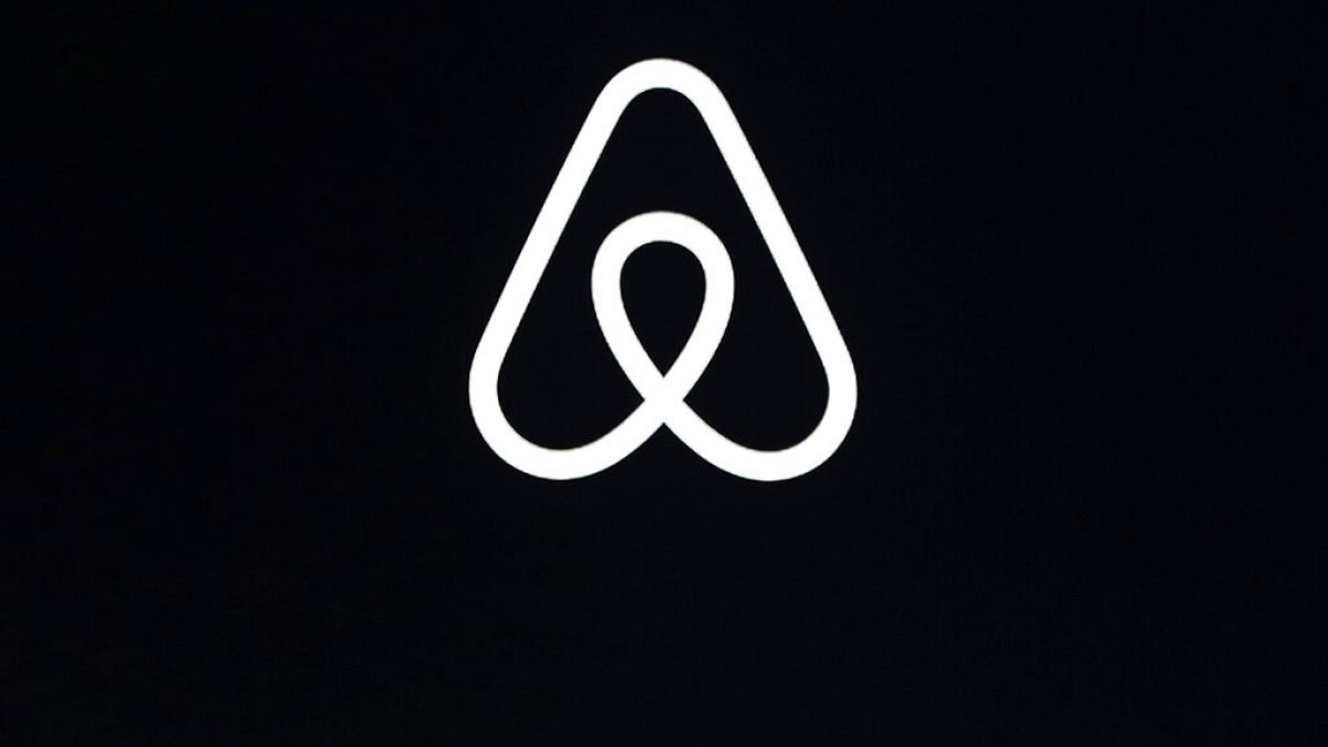 This Feb. 22, 2018, file photo shows an Airbnb logo during an event in San Francisco.