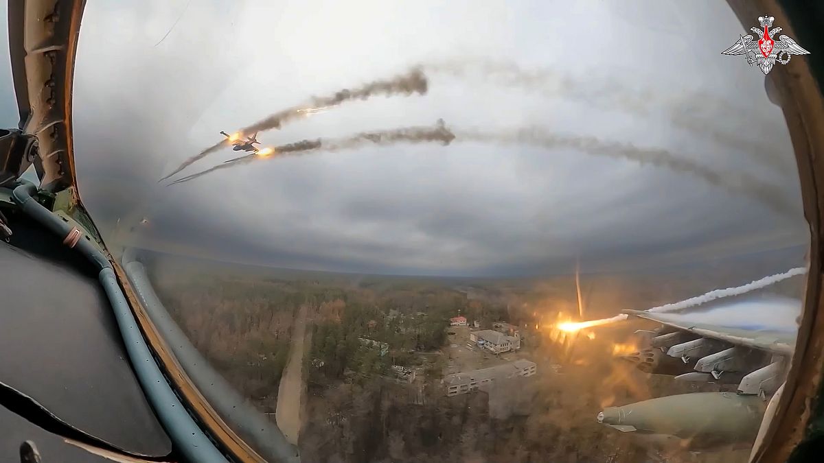 A Russian Su-25 warplane is seen from the cockpit of another such aircraft as they fire rockets on a mission over Ukraine.