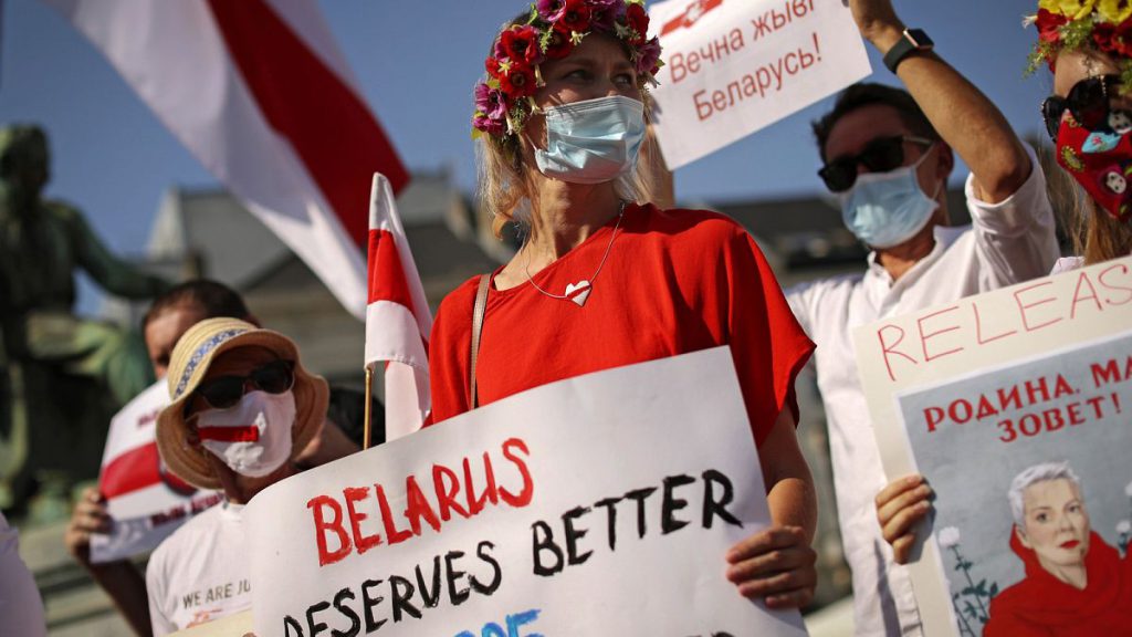 People shout slogans during a small protest against Belarusian President Alexander Lukashenko outside the European Parliament in Brussels, on Sept. 15, 2020.