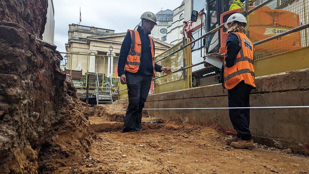 Archaeologists discuss the final bit of planning of the excavation at the National Gallery