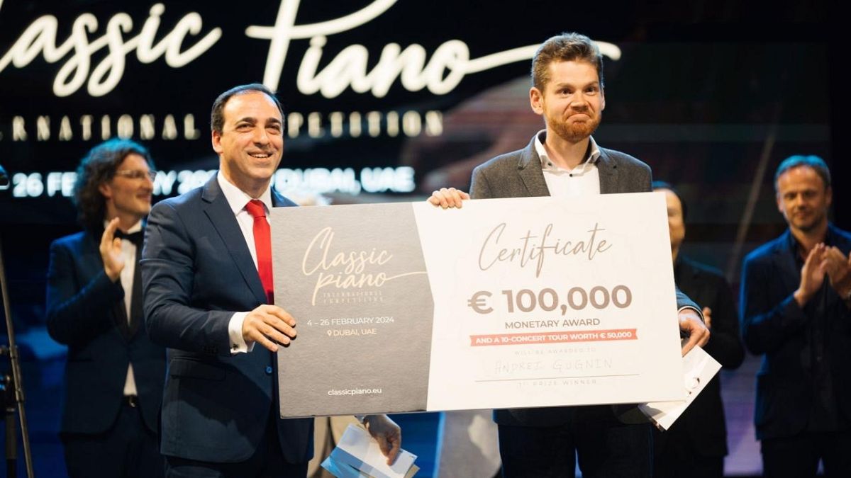 Andrey Gugnin receiving a €100,000 cheque at the final of the Classic Piano International Competition.