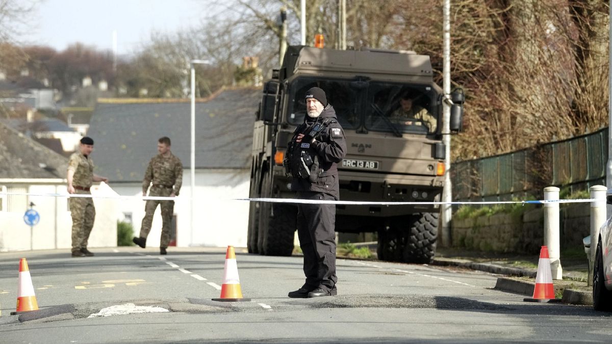 Police and bomb disposal experts stand at the scene near St Michael Avenue following the discovery of a suspected WWII explosive device, in Plymouth, England, Feb. 23, 2024.