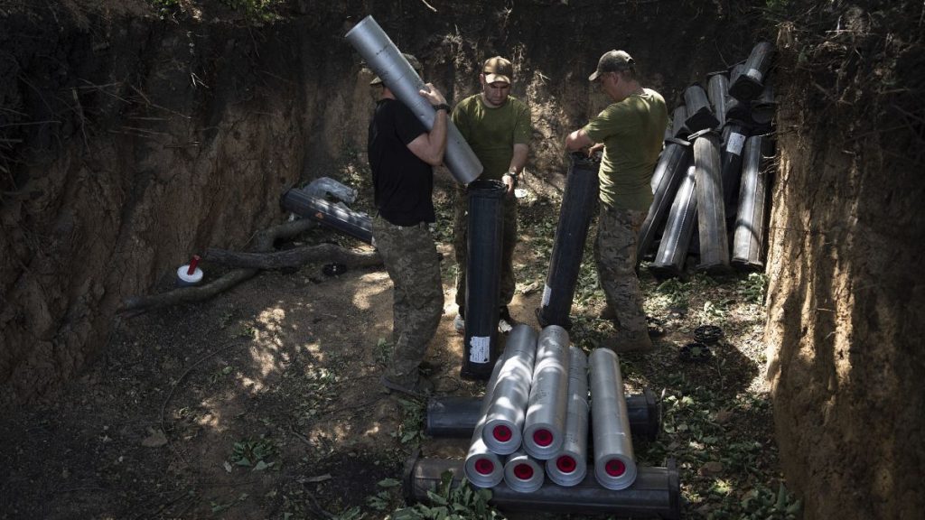 Ukrainian servicemen prepare ammunition before firing towards Russian positions near Bakhmut, Ukraine, July 7, 2023.