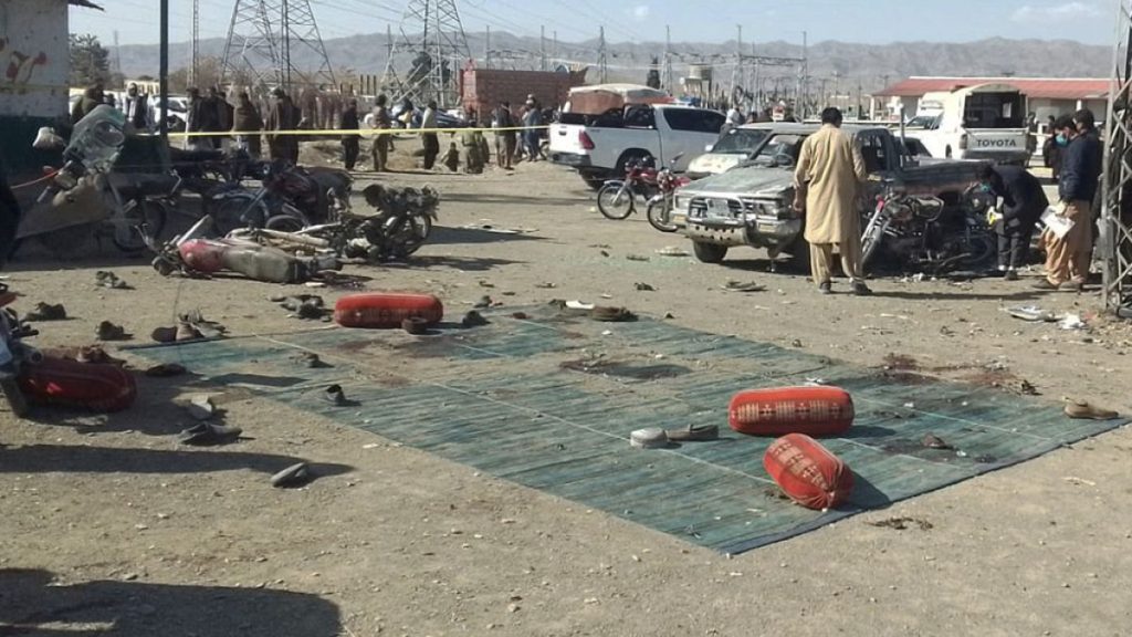 Security officials examine the scene of a bomb blast in Khanozai, Pashin, a district of Pakistan