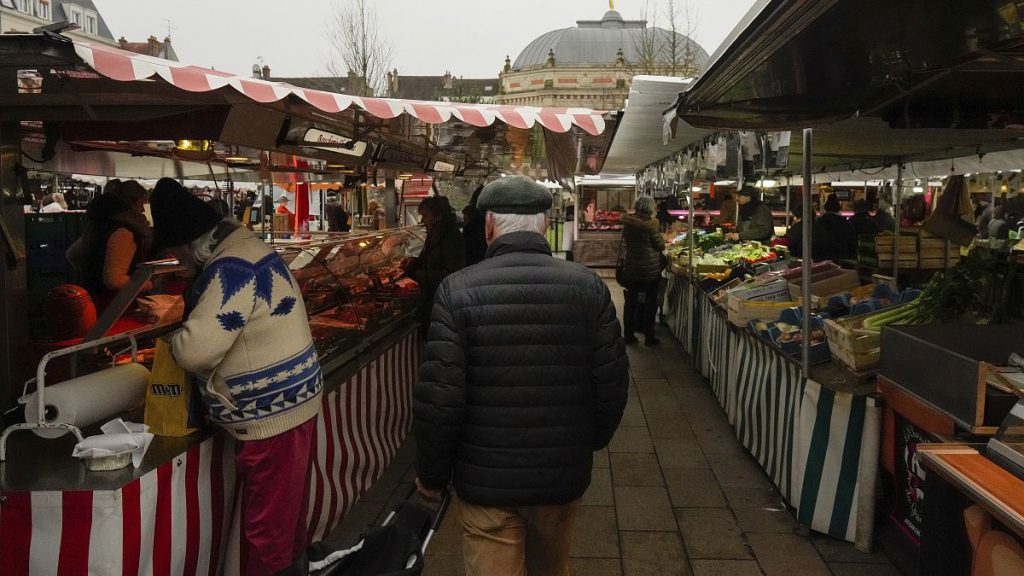 People shop at an open air market in Fontainebleau, south of Paris, France, Friday, Feb. 2, 2024.