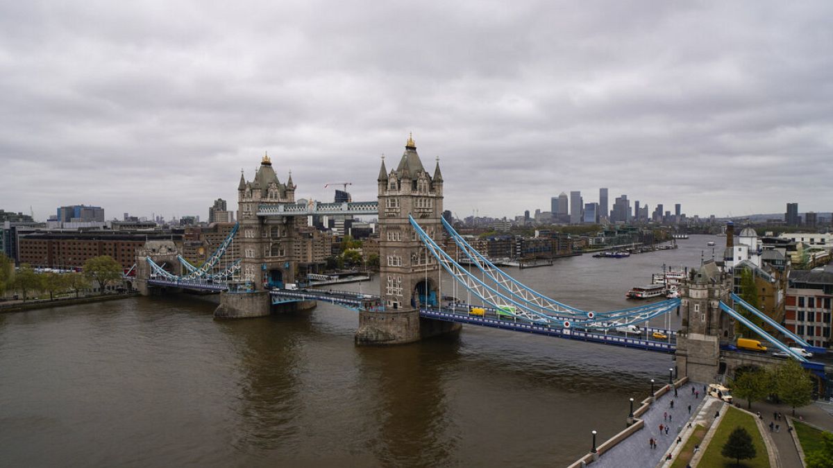 Tower Bridge in London, Saturday, May 8, 2021, against the backdrop of the skyline of the financial district.