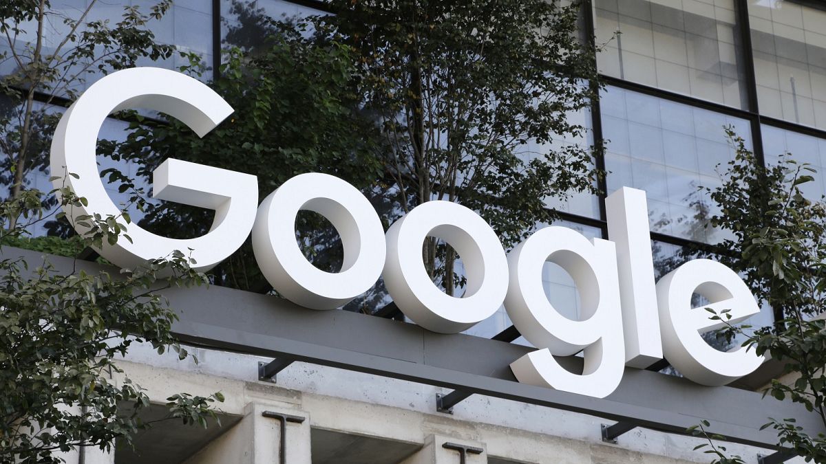 A Google sign hangs over an entrance to the company