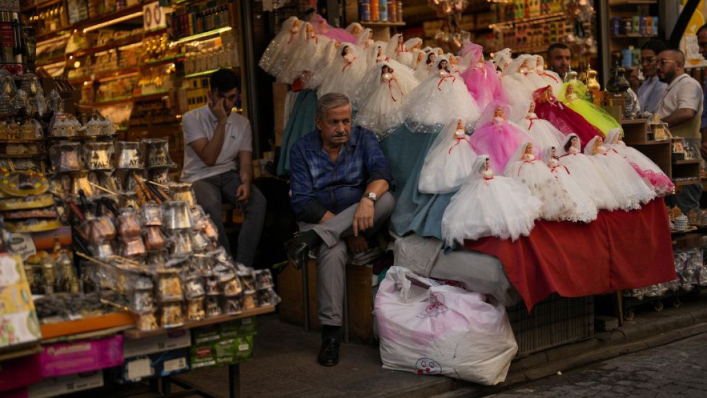 Sellers wait for clients in a street market in Istanbul, Turkey, Wednesday, Sept. 6, 2023.