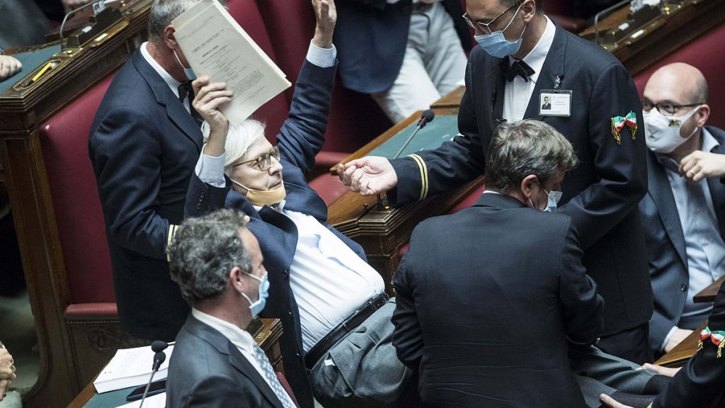 Vittorio Sgarbi resigns - pictured here being carried out of the Chamber of Deputies by parliamentary assistants after arguing with other lawmakers