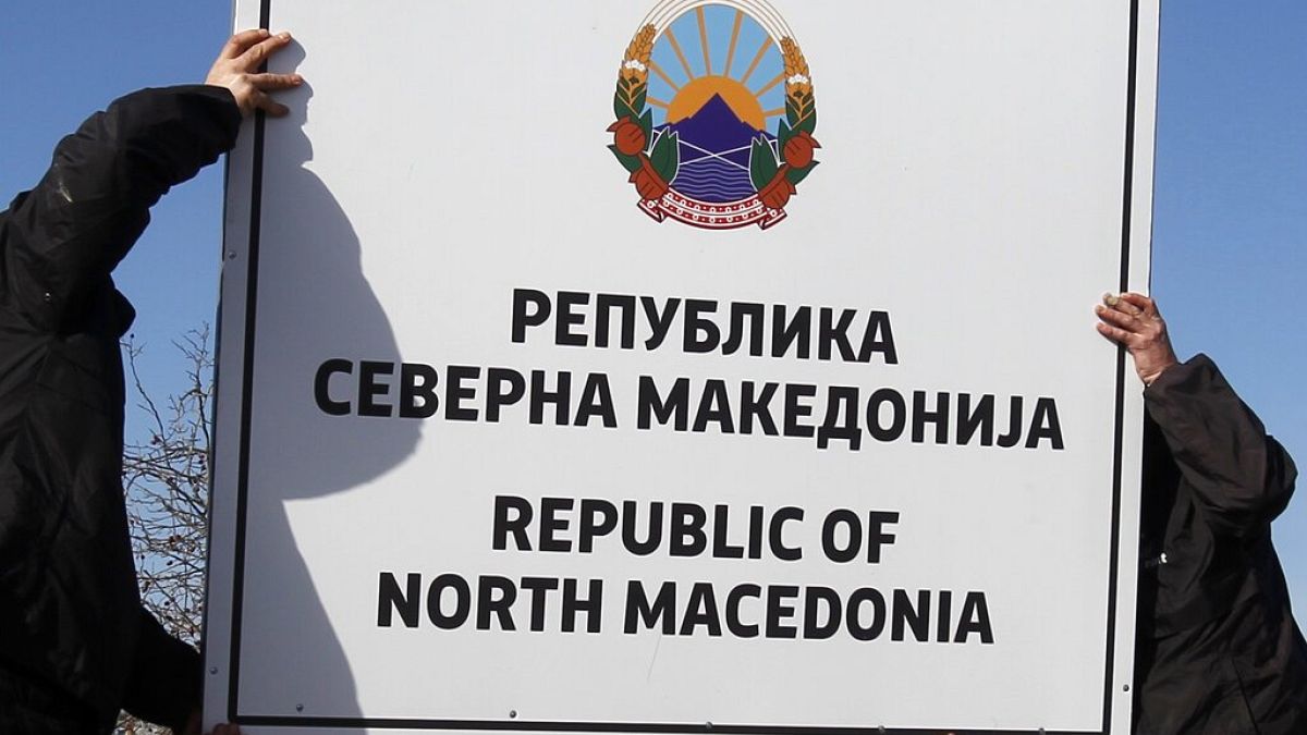 Workers install a new road sign with the name Republic of North Macedonia in the southern border with Greece, near Gevgelija, Wednesday, Feb. 13, 2019.