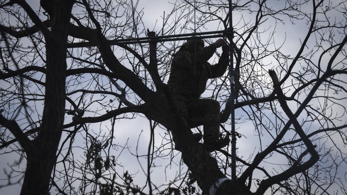 A Ukrainian soldier installs an electronic warfare system antenna to listen to Russian chatter at the front line near Bakhmut, Donetsk region, Ukraine, Monday, Jan. 29, 2024.