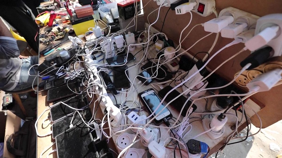 Cellphones connected to electricity suppliers to charge them from solar panels.