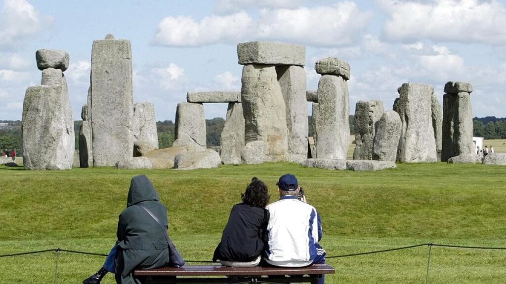 Tourists looking at The Stonehenge on Salisbury Plain in England.