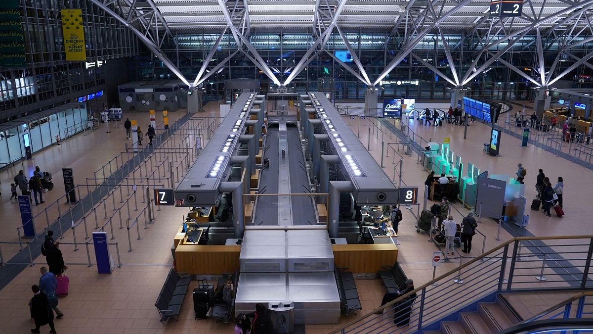 Passengers stand at the Lufthansa check-in area in Terminal 2 at an airport in Hamburg, Germany Thursday, Feb. 8, 2024.