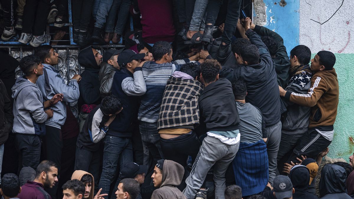 Palestinian crowds struggle to buy bread from a bakery in Rafah, Gaza Strip, Feb. 18, 2024.