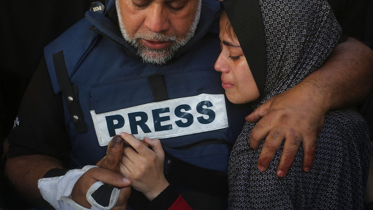 Al Jazeera journalist Wael Dahdouh holds the hand of his son Hamza, who also worked for Al Jazeera and who was killed in an Israeli airstrike in Rafah, Jan. 7, 2024.