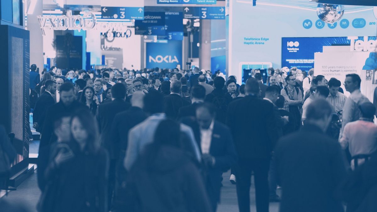 Crowds mill through the exhibition spaces of the 2024 Mobile World Congress in Barcelona.