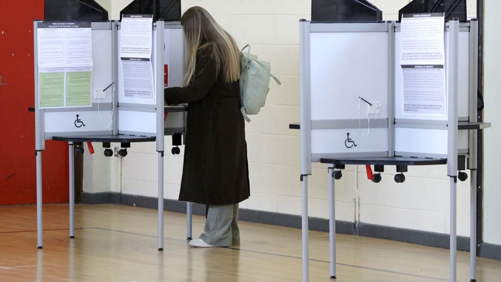 A woman votes in a referendum on the proposed changes to the wording of the Constitution relating to the areas of family and care.