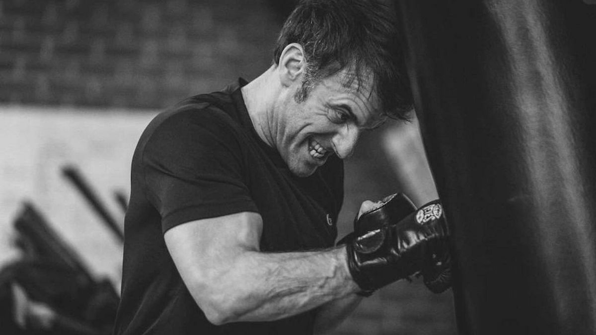 An official photo showing Emmanuel Macron hitting a punch bag.