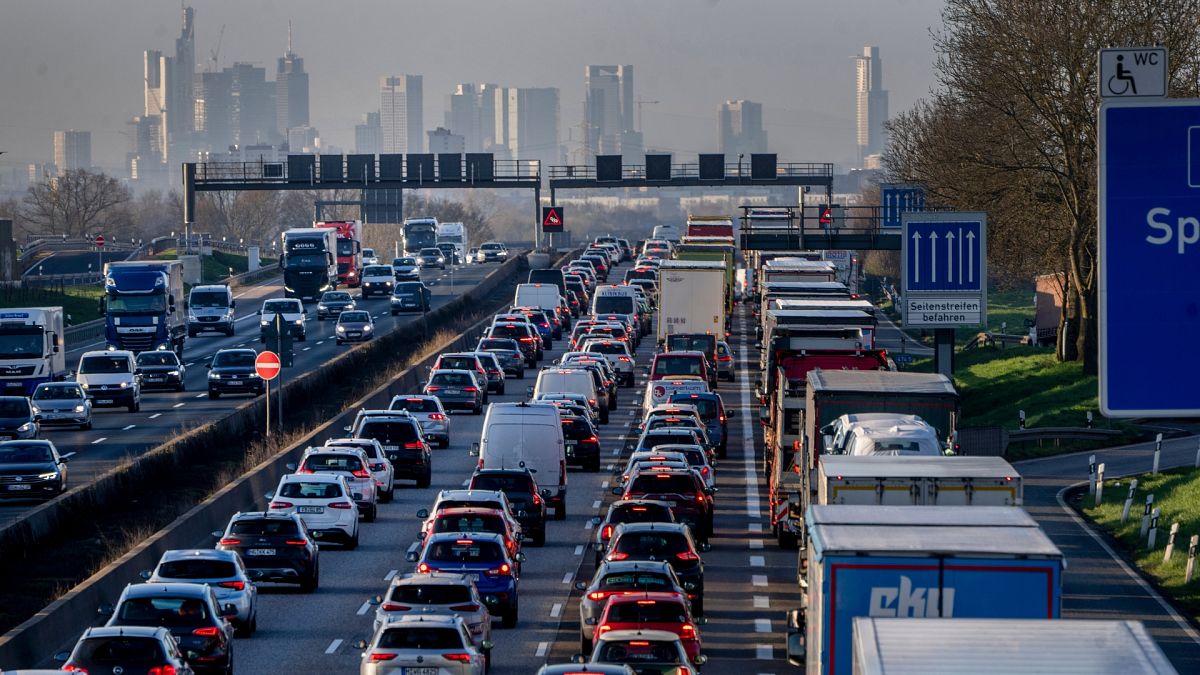 Cars and trucks queue in a traffic jam on a highway near Frankfurt, Germany.