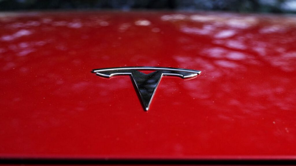 A Tesla logo is seen on a vehicle on display in Austin, Texas, Wednesday, Feb. 22, 2023.