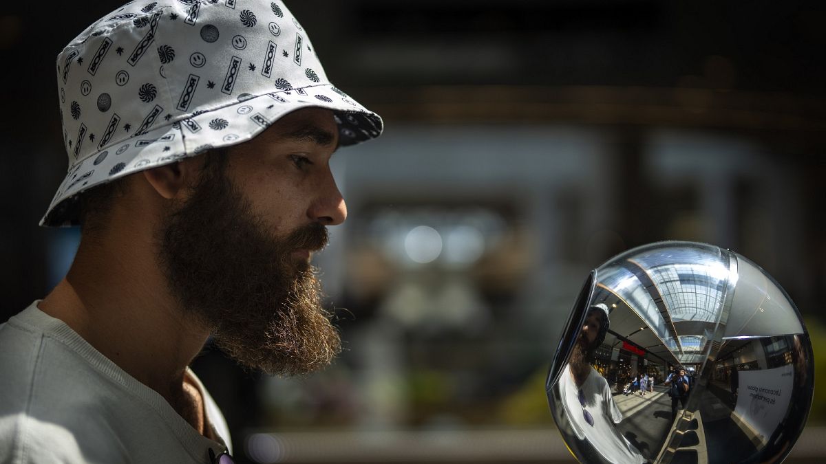 aniel Kertusha, 21, has his eyes scanned by an orb at a Worldcoin registration point in Barcelona, Spain, Friday, August 4, 2023.