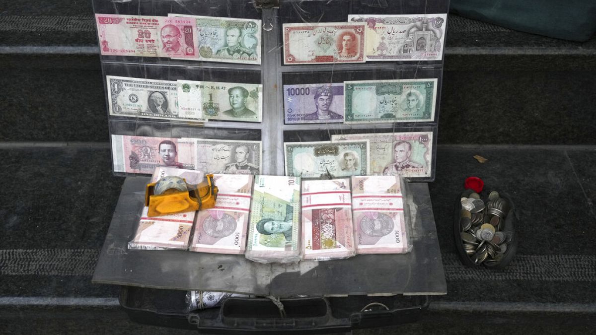 Current and pre-revolution Iranian banknotes and foreign currencies are displayed by a vendor at a commercial district in downtown Tehran, Iran, Friday, Dec. 23, 2022.